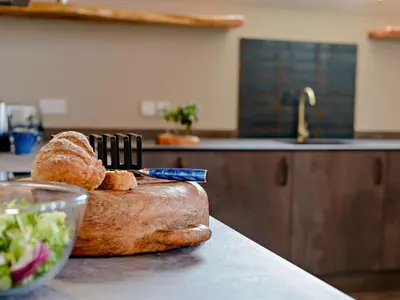 a loaf of bread on a cutting board with a knife at 3 Bed in Newquay oc-90068 in Newquay