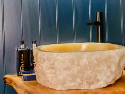 a stone bowl sitting on top of a wooden table at 3 Bed in Newquay oc-90068 in Newquay