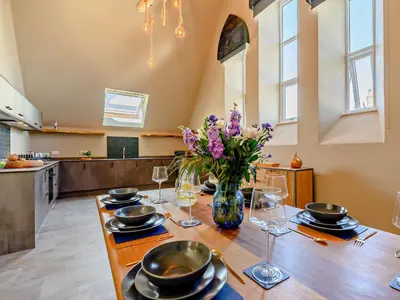 a dining room with a table with a vase of flowers at 3 Bed in Newquay oc-90068 in Newquay