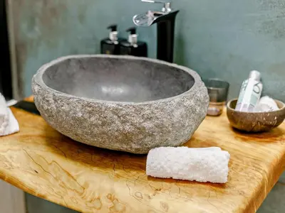 a stone bowl sink on a wooden counter with a block of soap at 3 Bed in Newquay oc-90070 in Newquay