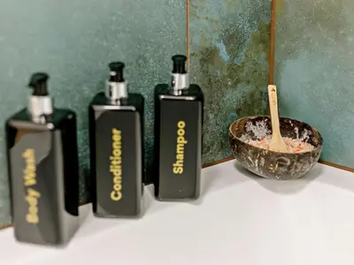 a group of three bottles of soap and a bowl at 3 Bed in Newquay oc-90070 in Newquay