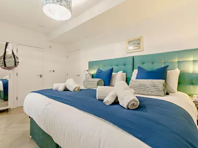 a blue and white bedroom with a large bed at 3 Bed in Newquay oc-90070 in Newquay