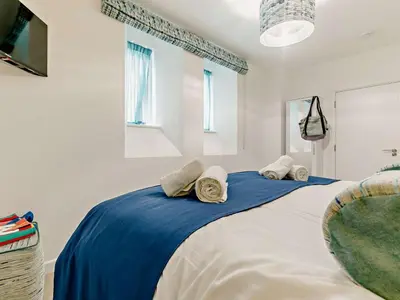 a bedroom with a large bed with two pillows on it at 3 Bed in Newquay oc-90070 in Newquay