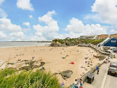 a group of people on a beach near the water at 3 Bed in Newquay oc-90070 in Newquay