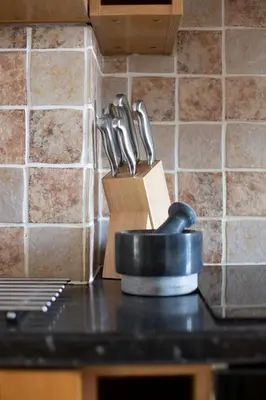 a group of knives in a knife block on a counter at Cornish Cottage - Sleeps 8/9 in Helston