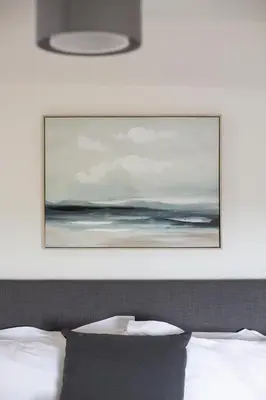 a painting above a bed in a bedroom at Cornish Cottage - Sleeps 8/9 in Helston