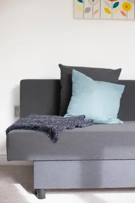 a bed with a purple blanket on it in a room at Cornish Cottage - Sleeps 8/9 in Helston