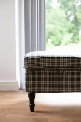 a ottoman sitting in front of a window at Cornish Cottage - Sleeps 8/9 in Helston