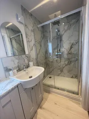 a bathroom with a sink and a shower at Bumblebee Barn, Luxury contemporary holiday home in Perranporth