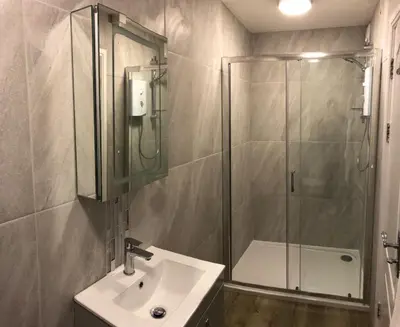 a bathroom with a glass shower and a sink at Beacon Hotel Self Catering Apartment in St. Agnes