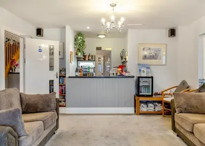 a living room with two couches and a bar at Beacon Hotel Self Catering Apartment in St. Agnes