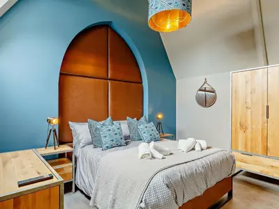 a bedroom with a large bed with a large headboard at 4 Bed in Newquay oc-90069 in Newquay