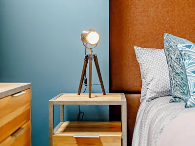 a lamp on a table next to a bed at 4 Bed in Newquay oc-90069 in Newquay