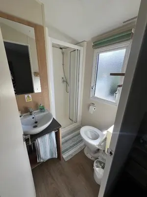 a bathroom with a sink and a toilet and a window at Willows Way Newquay Holiday Park in Newquay