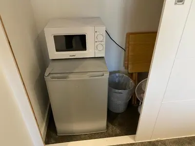 a microwave sitting on top of a refrigerator at Bed and breakfast near Truro and the A30 in Truro