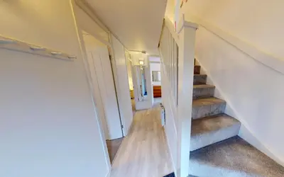 a staircase in a house with wooden floors at St Ives Bluebell Cottage in St Ives