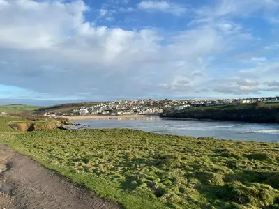 a view of a river with houses in the distance at Cosy Cornish cottage with rural views in Newquay