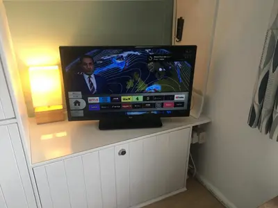 a flat screen tv sitting on top of a cabinet at Cosy Cornish cottage with rural views in Newquay