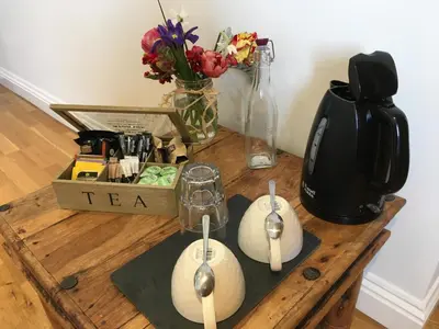 a table with a tea kettle and spoons on it at Number Six in St. Agnes