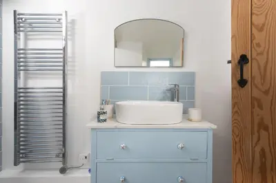 a bathroom with a sink and a mirror at School Cottage, Marazion in Marazion