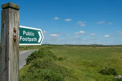 a street sign on a pole next to a road at Trippet Cottage in Saint Breward