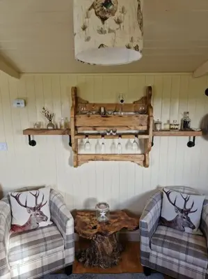 a living room with two couches and a table at Shepherds haven hut Near Padstow in Saint Issey
