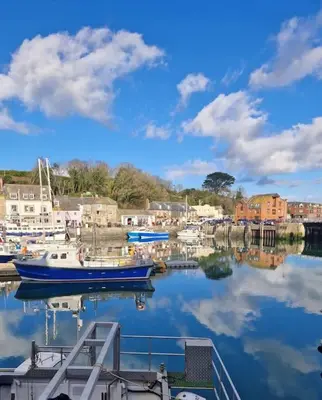 a group of boats docked in a harbor at Shepherds haven hut Near Padstow in Saint Issey
