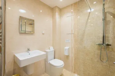 a bathroom with a toilet and a sink and a shower at Jubilee Cottage - Cwc75016 in Saint Breward