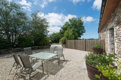 a patio with a table and chairs and a fence at Jubilee Cottage - Cwc75016 in Saint Breward