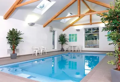 a swimming pool in a house with skylights at Villa Gallery in Truro