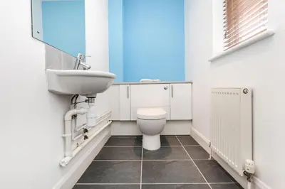 a bathroom with a sink and a toilet at Villa Gallery in Truro