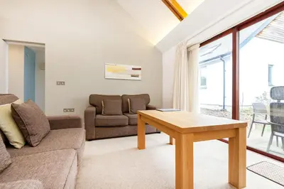 a living room with a couch and a table at Villa Gallery in Truro