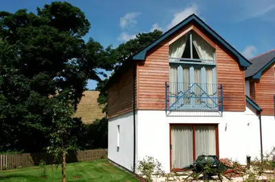 a house with a white and brown building at Haven in Truro