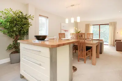a kitchen and dining room with a counter and a table at Haven in Truro