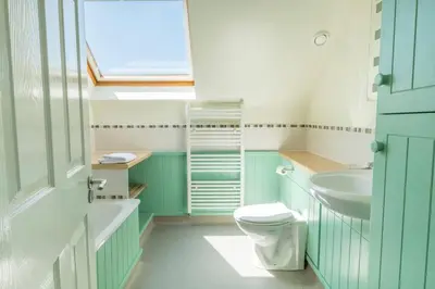 a bathroom with a toilet and a sink at Flat 1 Mawgan Porth Golf Club in Mawgan Porth