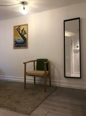 a chair sitting in a room with a mirror at The Loft - Bright apartment centre St Ives sleep 4 in St Ives