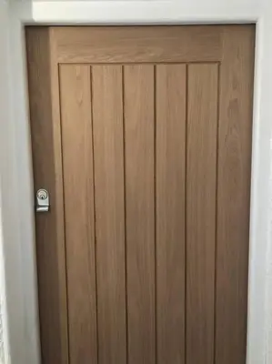 a wooden door in a white room with at The Loft - Bright apartment centre St Ives sleep 4 in St Ives