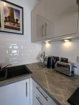 a kitchen with a counter top with a microwave at The Loft - Bright apartment centre St Ives sleep 4 in St Ives