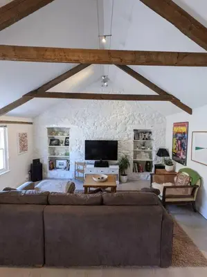 a living room with a couch and a tv at The Loft - Bright apartment centre St Ives sleep 4 in St Ives