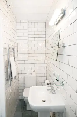 a white bathroom with a sink and a toilet at The Lerryn in Falmouth