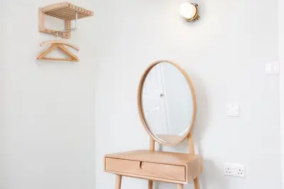 a dressing table with a mirror and a stool at The Lerryn in Falmouth