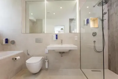 a bathroom with a toilet and a sink and a shower at St Michaels Resort, Falmouth in Falmouth