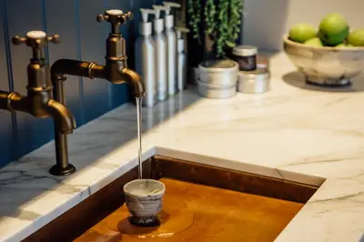 a kitchen sink with a water faucet at Merchants Manor Spa in Falmouth