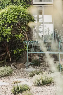 a green bench sitting in front of a building at Merchants Manor Spa in Falmouth