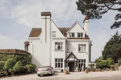 a house with a car parked in front of it at Merchants Manor Spa in Falmouth