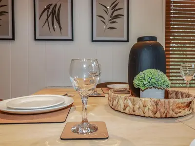 a table with a wine glass on top of it at 1 Streamside in Looe