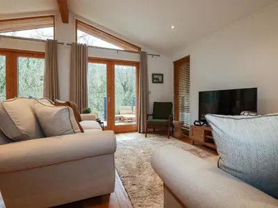 a living room with two couches and a flat screen tv at 1 Streamside in Looe