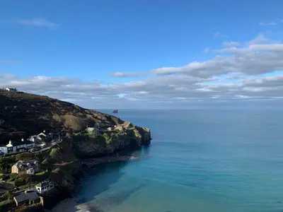 an aerial view of the ocean with houses on a cliff at St Agnes Hotel in St. Agnes