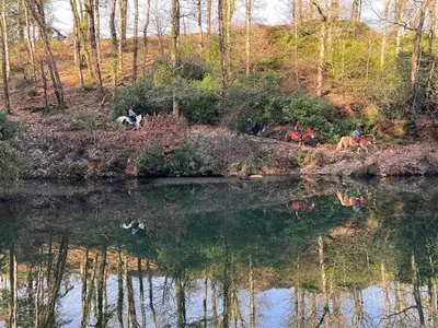 a group of people riding horses near a body of water at Two Bedroom Lodge In The Country - Restaurant Bar Onsite in Liskeard