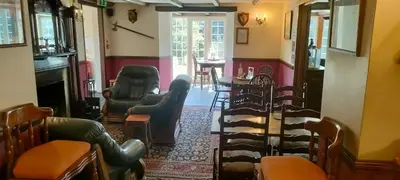 a living room with chairs and a table in a room at Two Bedroom Lodge In The Country - Restaurant Bar Onsite in Liskeard